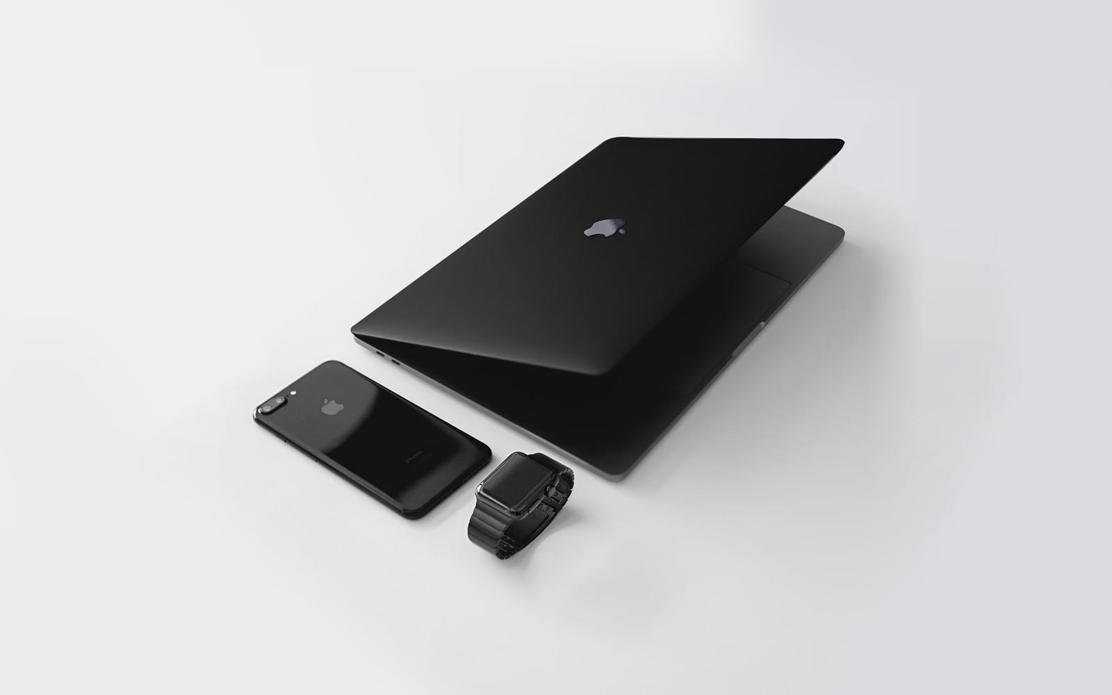 Photo by Julian O'hayon black Macbook near black iPhone 7 Plus and black Apple Watch