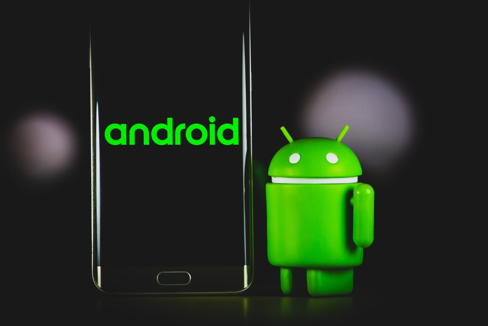 Photo by Denny Müller green frog iphone case beside black samsung android smartphone